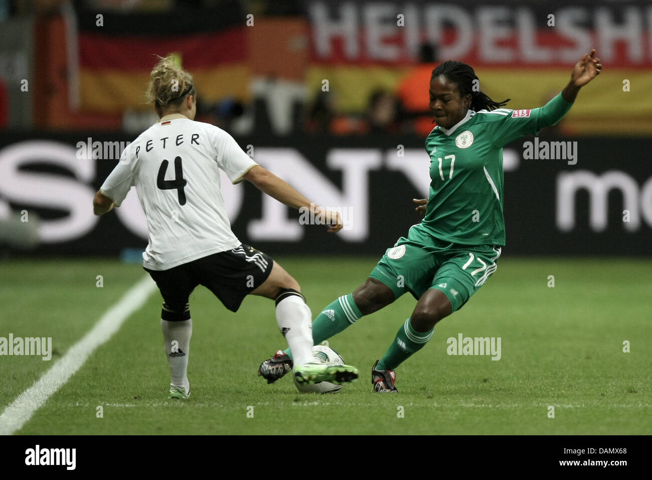 Babett Peter (l) of Germany and Francisca Ordega of Nigeria fight for the ball during the Group A match Germany against Nigeria of FIFA Women's World Cup soccer tournament at the FIFA Women's World Cup Stadium in Frankfurt, Germany, 30 June 2011. Foto: Fredrik von Erichsen dpa/lhe Stock Photo