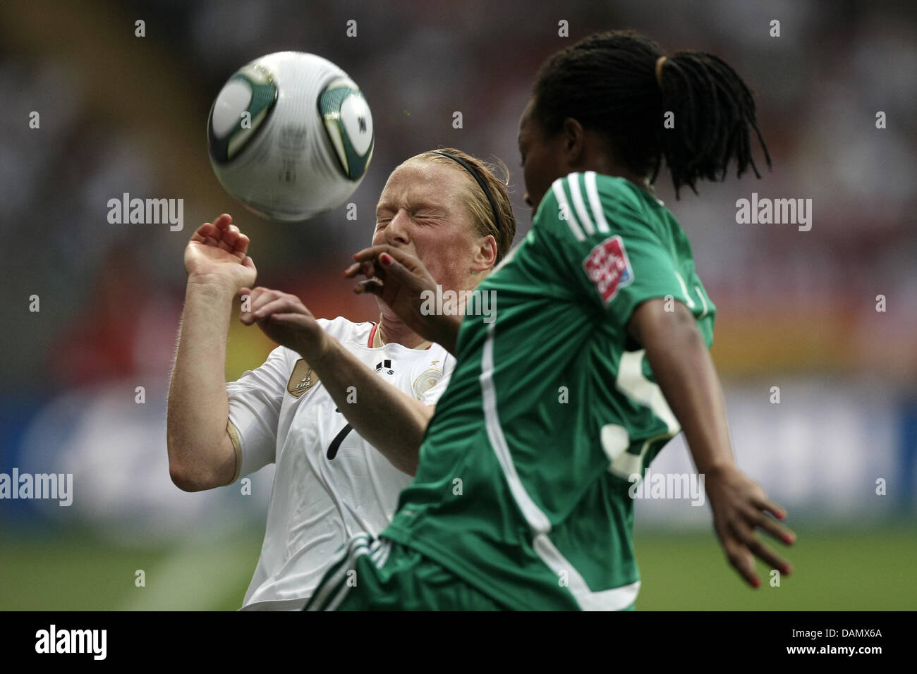 Melanie Behringer (l) of Germany and Onome Ebi of Nigeria fight for the ball during the Group A match Germany against Nigeria of FIFA Women's World Cup soccer tournament at the FIFA Women's World Cup Stadium in Frankfurt, Germany, 30 June 2011. Foto: Fredrik von Erichsen dpa/lhe Stock Photo