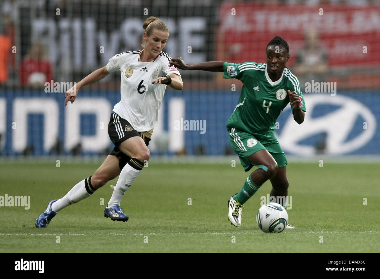 Simone Laudehr (l) of Germany and Perpetua Nkwocha of Nigeria fight for the ball during the Group A match Germany against Nigeria of FIFA Women's World Cup soccer tournament at the FIFA Women's World Cup Stadium in Frankfurt, Germany, 30 June 2011. Foto: Fredrik von Erichsen dpa/lhe Stock Photo