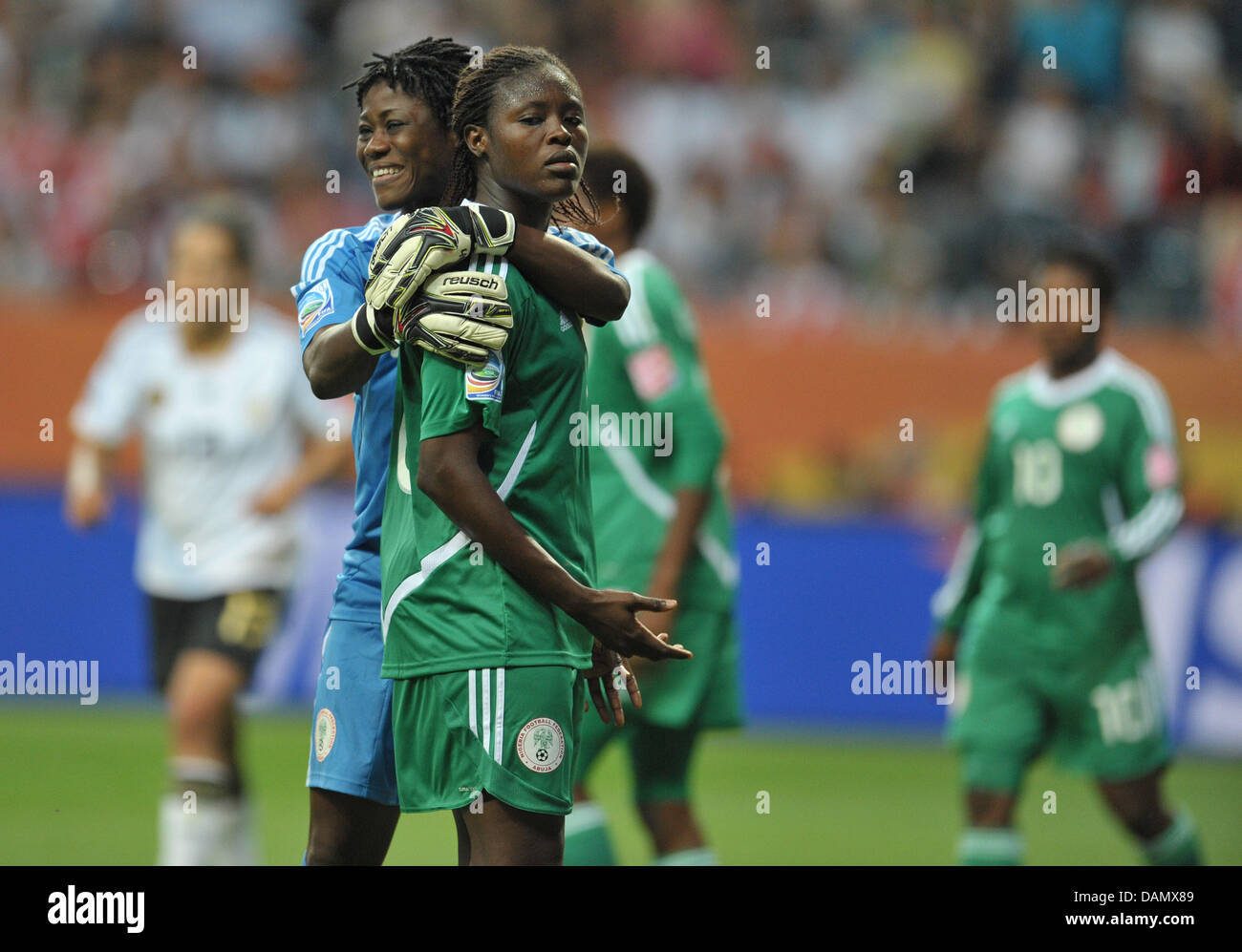 Nigeria's goalkeeper Precious Dede (L) and Onome Ebi hug during the Group A match Germany against Nigeria of FIFA Women's World Cup soccer tournament at the FIFA Women's World Cup Stadium in Frankfurt, Germany, 30 June 2011. Germany won the match with 1-0. Foto: Carmen Jaspersen dpa/lhe Stock Photo