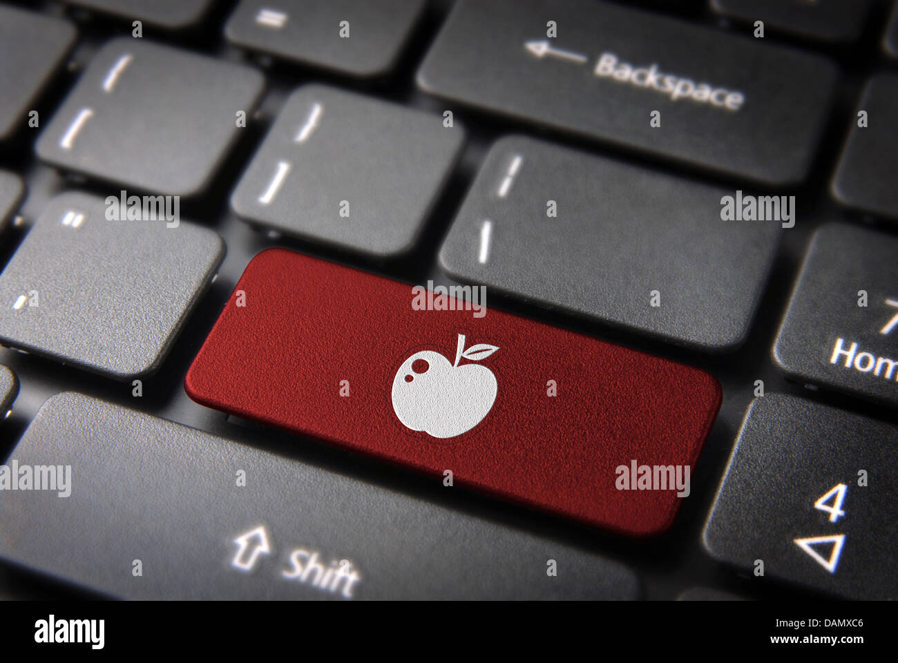 Love key with apple icon on laptop keyboard. Included clipping path, so you can easily edit it. Stock Photo