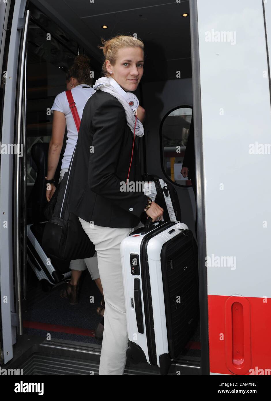 German women's national soccer player Simone Laudehr enters the ICE train from Frankfurt to Duesseldorf at the station in Frankfurt am Main, Germany, 01 July 2011. Germany's next FIFA Women's World Cup match will take place in Moenchengladbach on 5 July 2011. Photo: Markus Gilliar/GES-Sportfoto/DFB Stock Photo