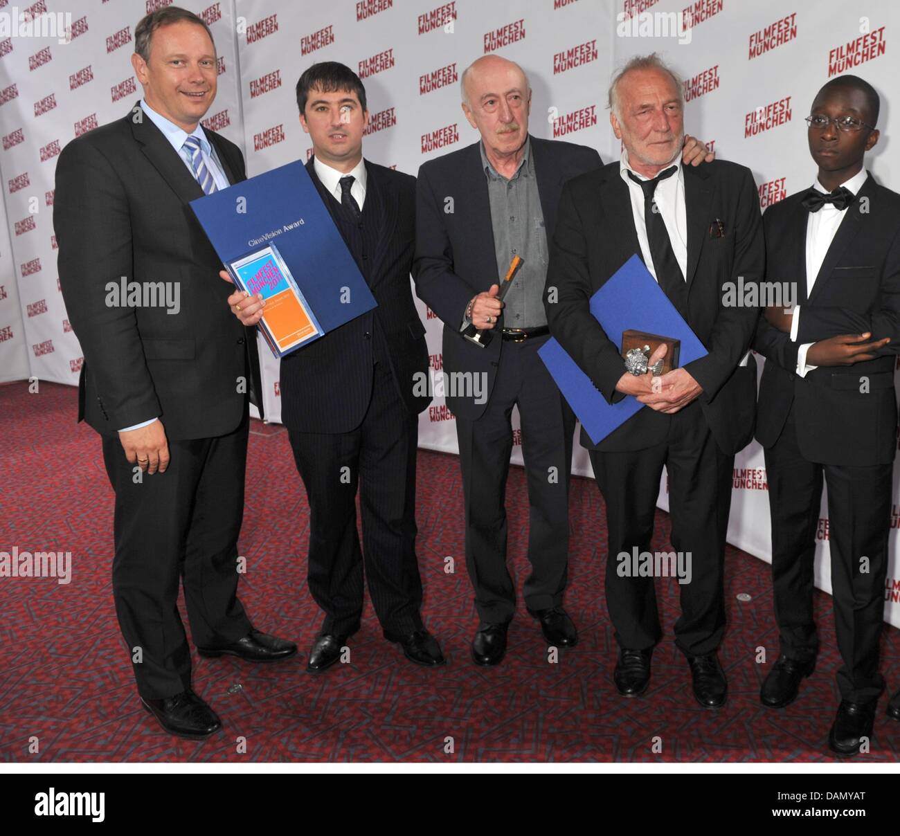The Bavarian Finance Georg Fahrenschon (L-R), the British actor Paul Popplewell, the Georgian director Otar Iosseliani, the French actor Andre Wilms and the actor Blondin Miguel pose after the awards ceremony of the CineVision Award in Munich, Germany, 01 July 2011. The awarding took place within the Film Festival Munich. Photo: Felix Hoerhager Stock Photo
