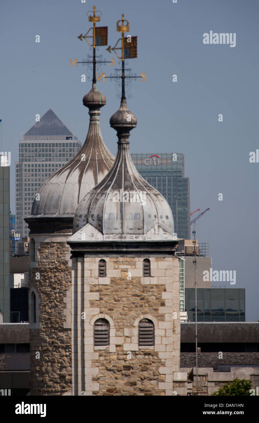 Close up of towers at Tower of London with Canary Wharf skyscrapers behind Stock Photo