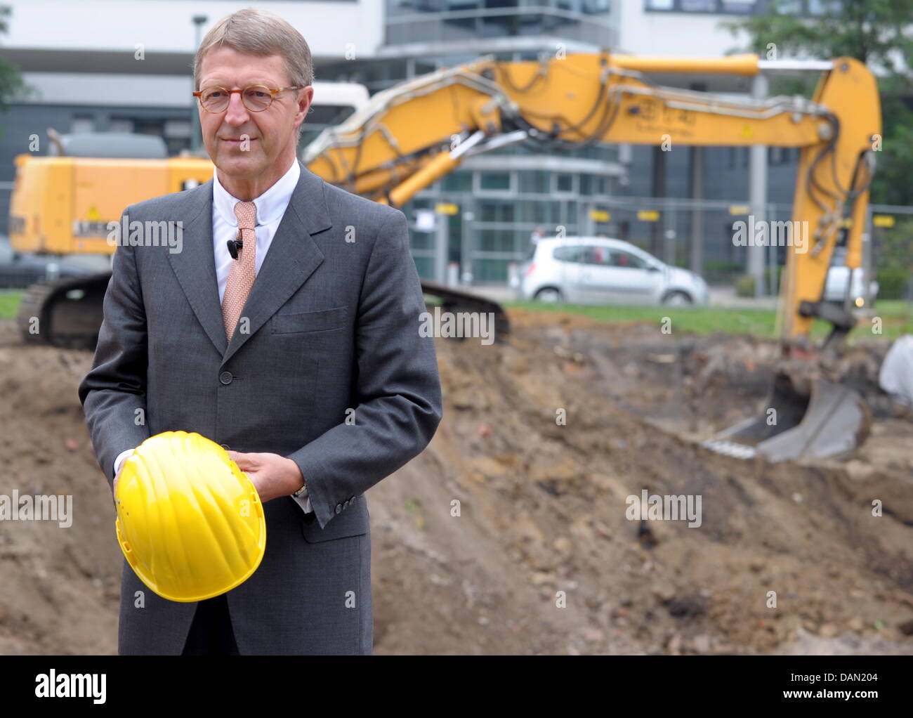 CEO of the Metro business group, Eckhard Cordes, stands at the construction site of company day care center in Duesseldorf, Germany, 04 July 2011. Until 2012, a massive reconfiguration is to produce an increase in synergy by 1.5 billion euro. 19,000 jobs were cancelled in stores and administration worldwide while the same amount of jobs have been created in new stores. Thanks to a  Stock Photo