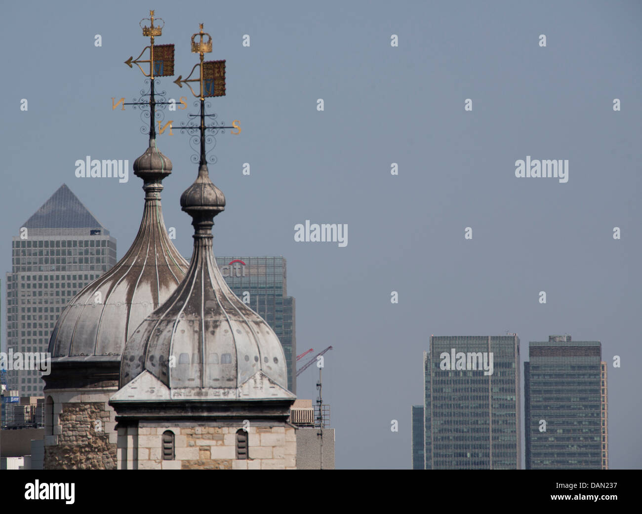 Close up of towers at Tower of London with Canary Wharf skyscrapers behind Stock Photo