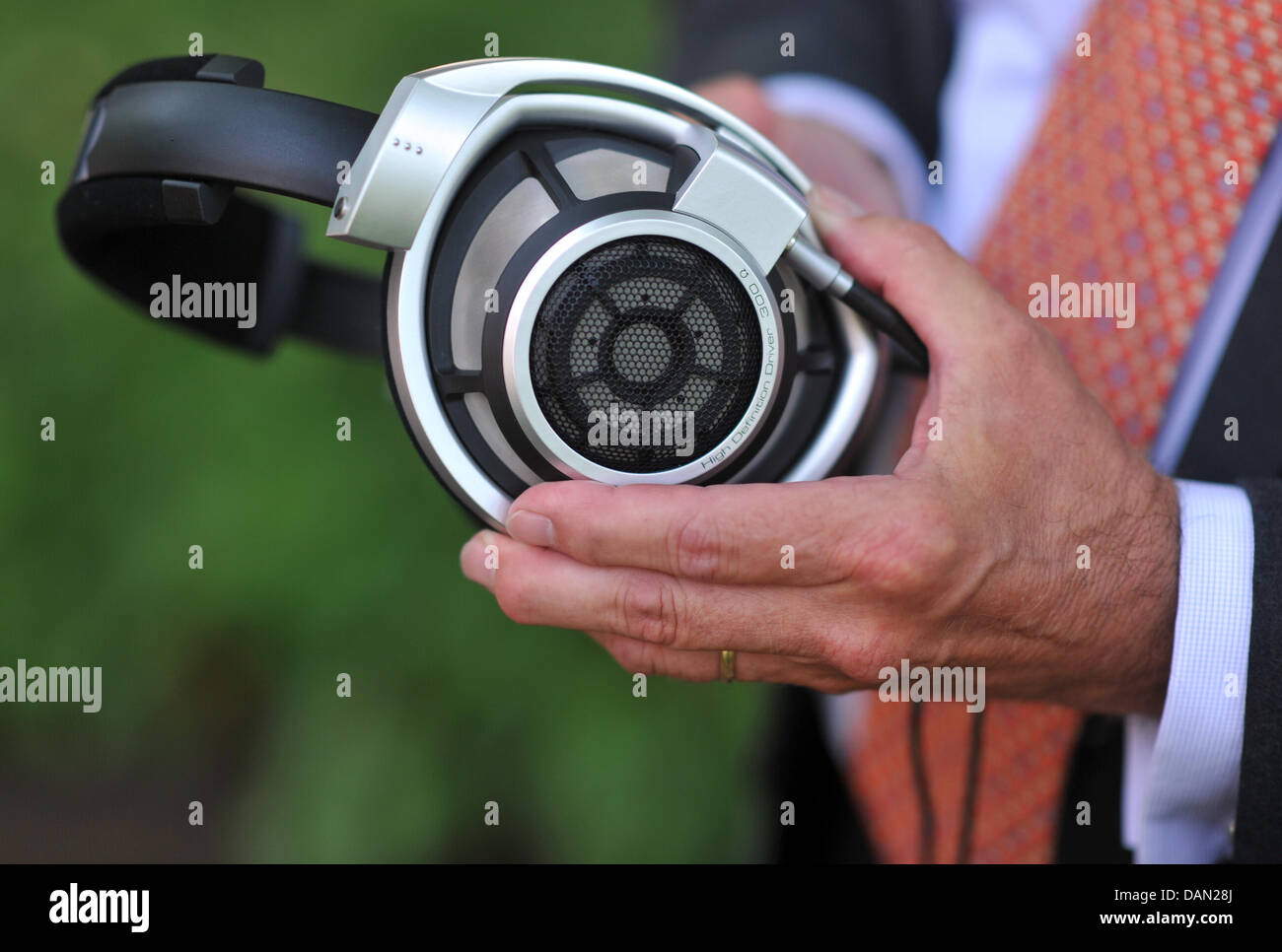 The chairman of the supervisory board of Sennheiser, Joerg Sennheiser,  holds the best and most expensive headphones made by Sennheiser, the HD  800, during a photo appointment in Wedemark, Germany, 15 June