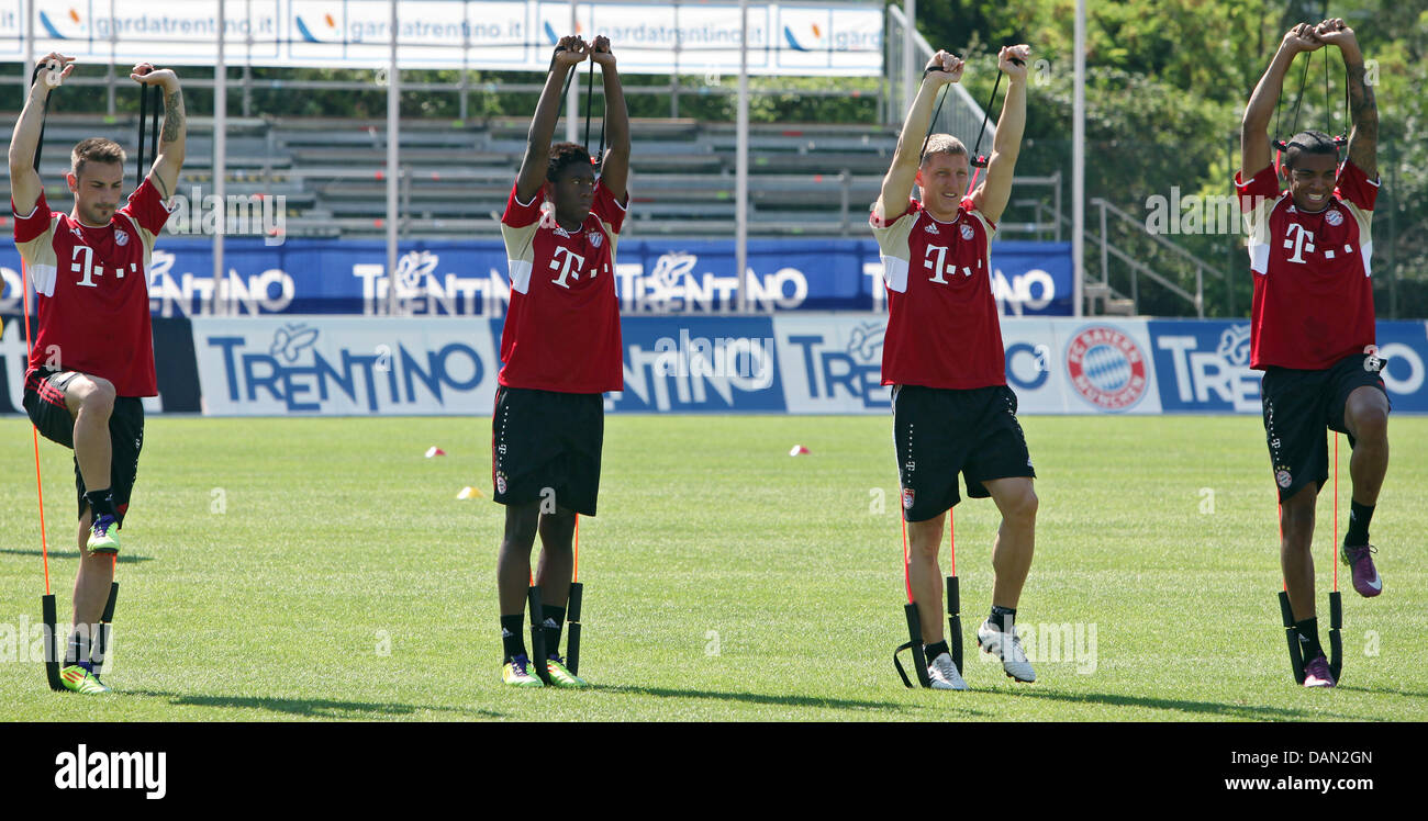 FC Bayern Munich's Diego Contento, David Alaba, Bastian Schweinsteiger and Luiz Gustavo (L-R) warm up during a practice session in Arco, Italy, 05 July 2011. From 03 to 09 July, the Bundesliga soccer club stays at Lake Garda for a training camp. Photo: Daniel Karmann Stock Photo