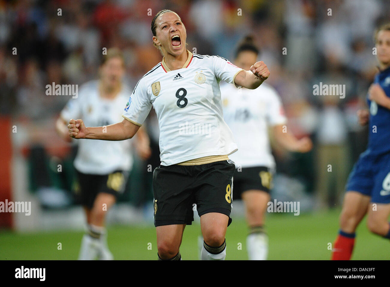 Germany's Inka Grings (R) celebrates scoring the 2-0 during the Group A