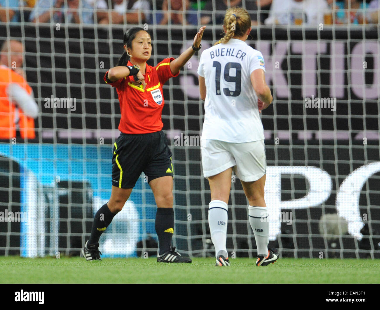 Referee Etsuko Fukano from Japan (L) gestures next to Rachel Buehler of