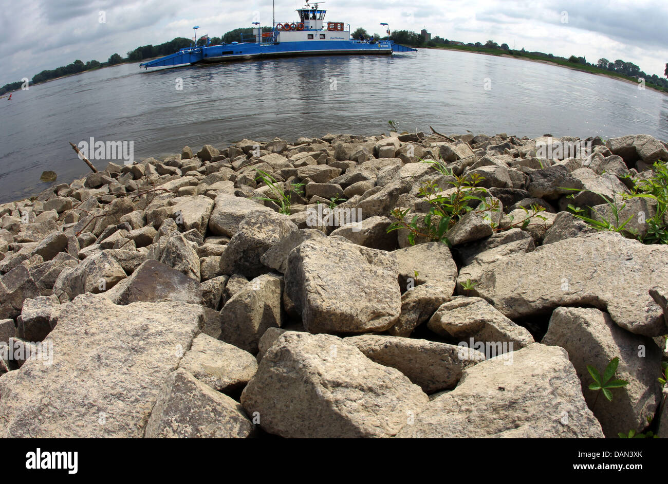 The ferryboat 'Amt Neuhaus' heads towards a landing pier while rocks of the riverside are visible in the forefront in Neu Blecke, Germany, 05 July 2011. The water level of the Elbe river has decreased in the last weeks, due to a recent drought. Waterway transport is yet not affected. Photo: Jens Buettner Stock Photo