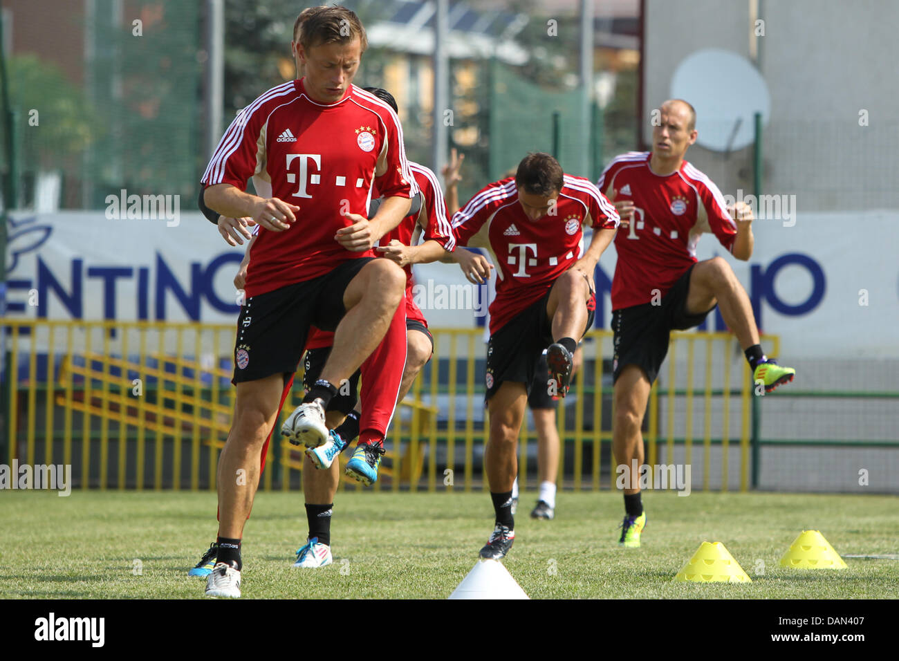 Players of FC Bayern Munich Ivica Olic (L), Rafinha (C) and Arjen Robben run across the soccer field during a training session in Arco at Lake Garda, Italy, 06 July 2011. The Bundesliga team practices at the training camp until 09 July 2011. Photo: Daniel Karmann Stock Photo
