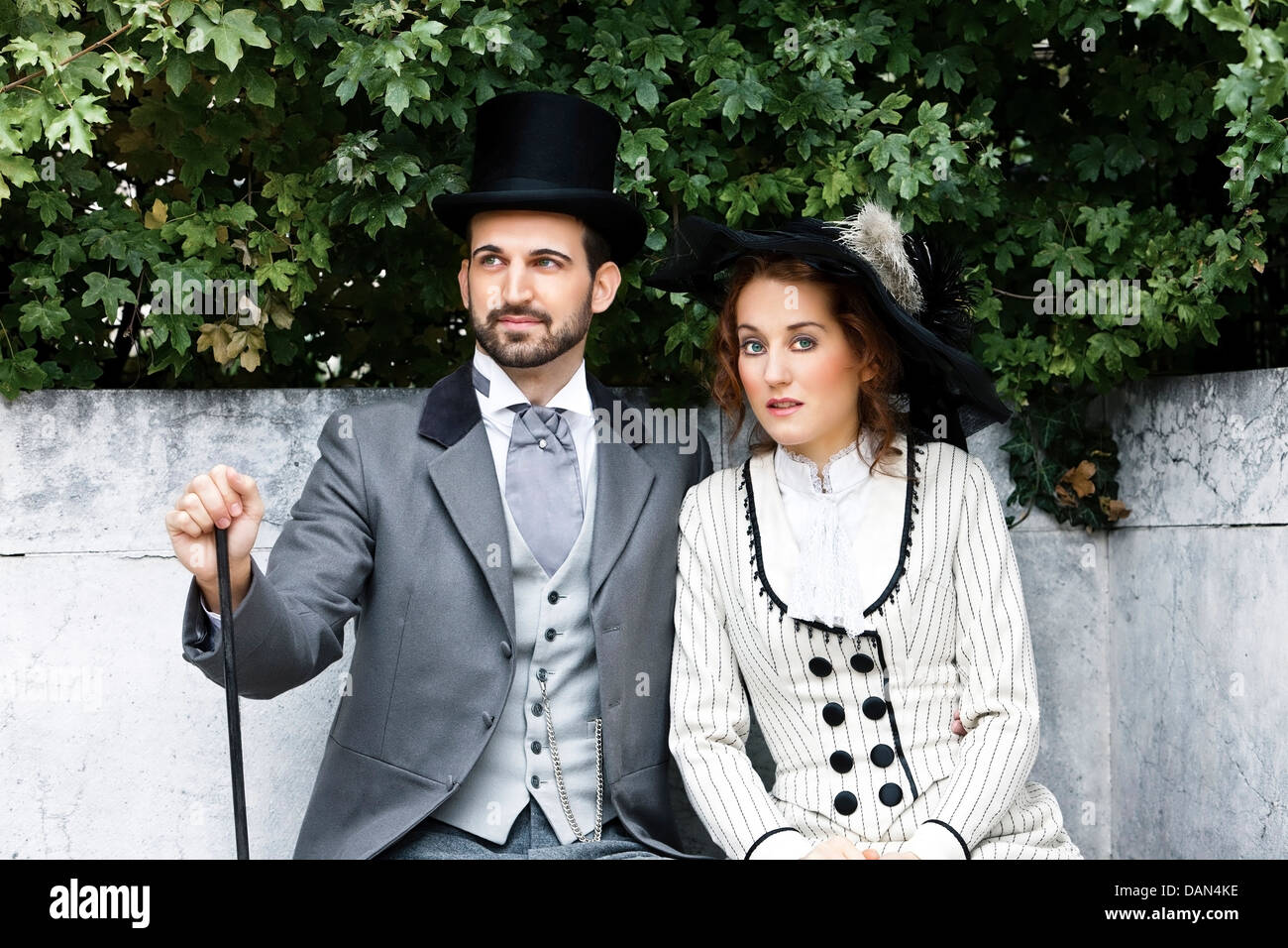 Old-fashioned dressed couple in the park Stock Photo