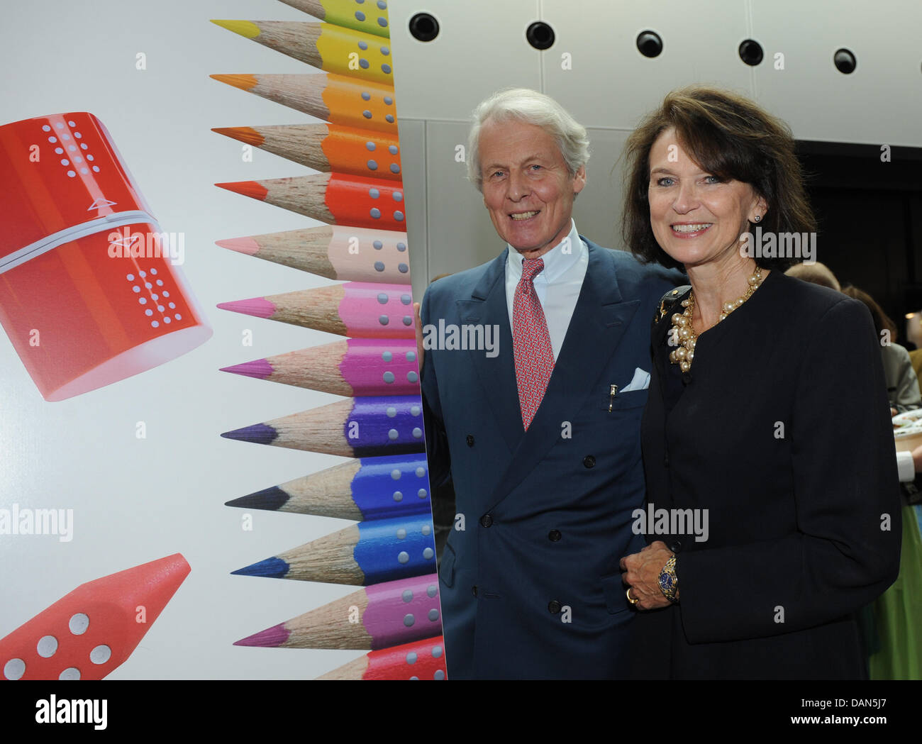 Head of the company Anton Wolfgang Duke of Faber Castell and his wife Mary pose next to a picture of pencils after the official ceremony of the 250th anniversary of  the stationery manufacturer Faber-Castell at Franken hall in Nuremberg, Germany, 08 July 2011. Photo: Armin Weigel Stock Photo