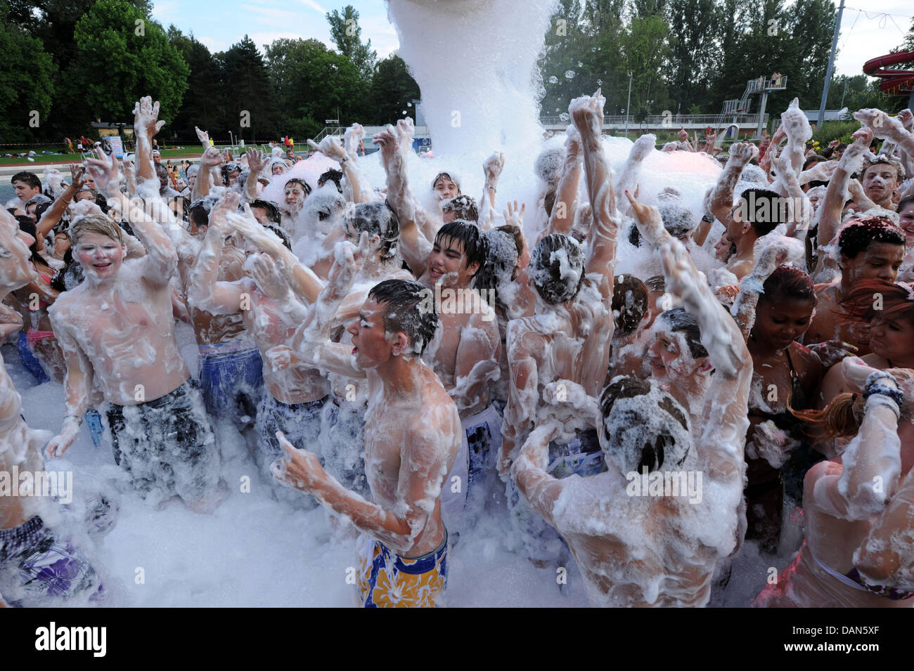 A foam party takes place at the public pool Rheinstrandbad Rappenwoert  during midsummer swimming in Karlsruhe, Germany, 08 July 2011. The public  pool operators were afraid that 6,000 people would come instead