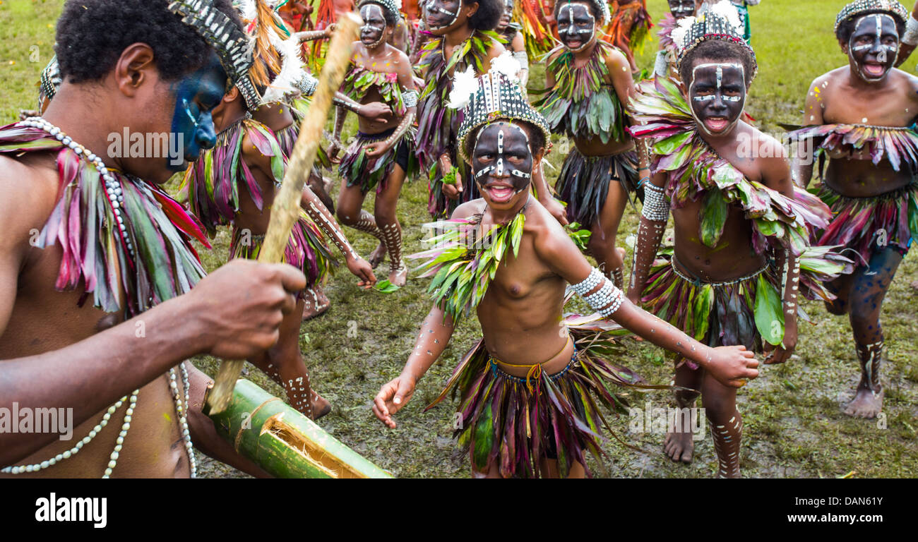 Children wearing traditional leaf costumes and dancing at the Goroka show in Papua New Guinea. Stock Photo