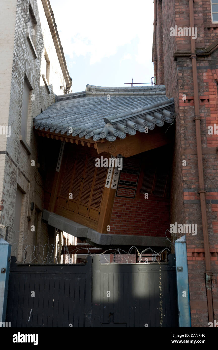 Chinese house squeezed between tall buildings art Stock Photo