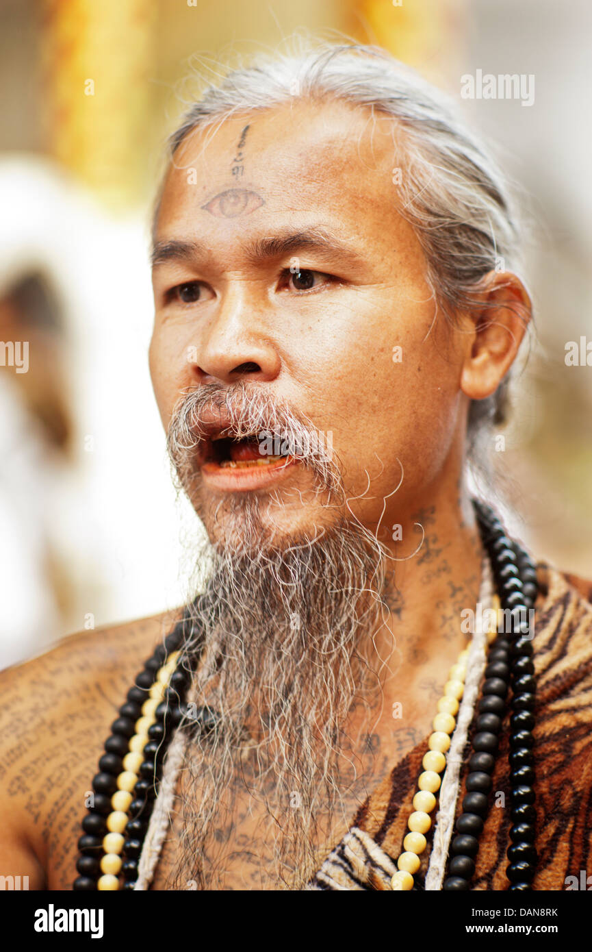 Heavily tattooed animist hermits say healing prayers and tell fortunes at Doi Suthp Buddhist temple in Chiang Mai, Thailand. Stock Photo