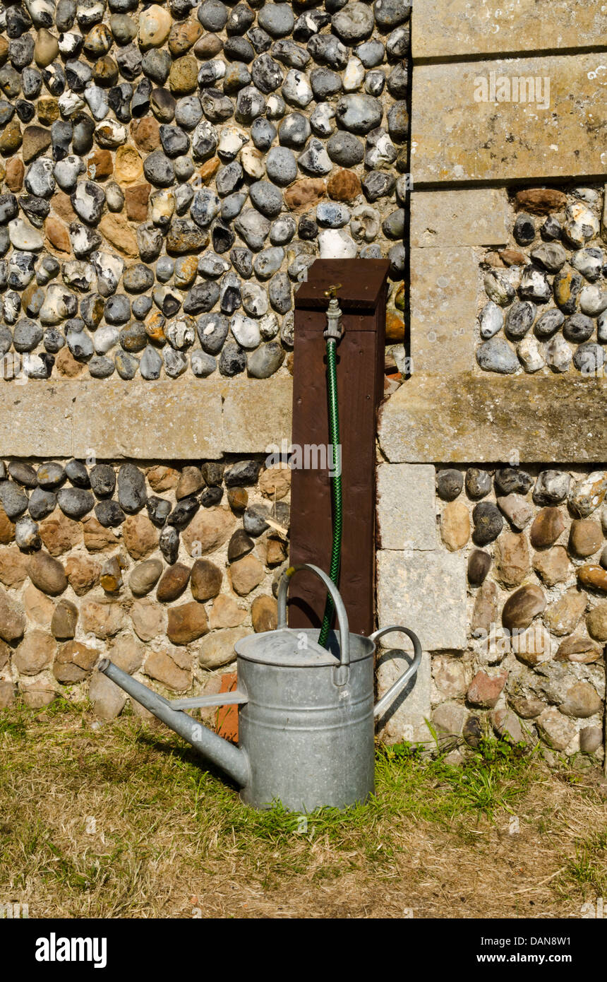 watering can and hosepipe Stock Photo Alamy