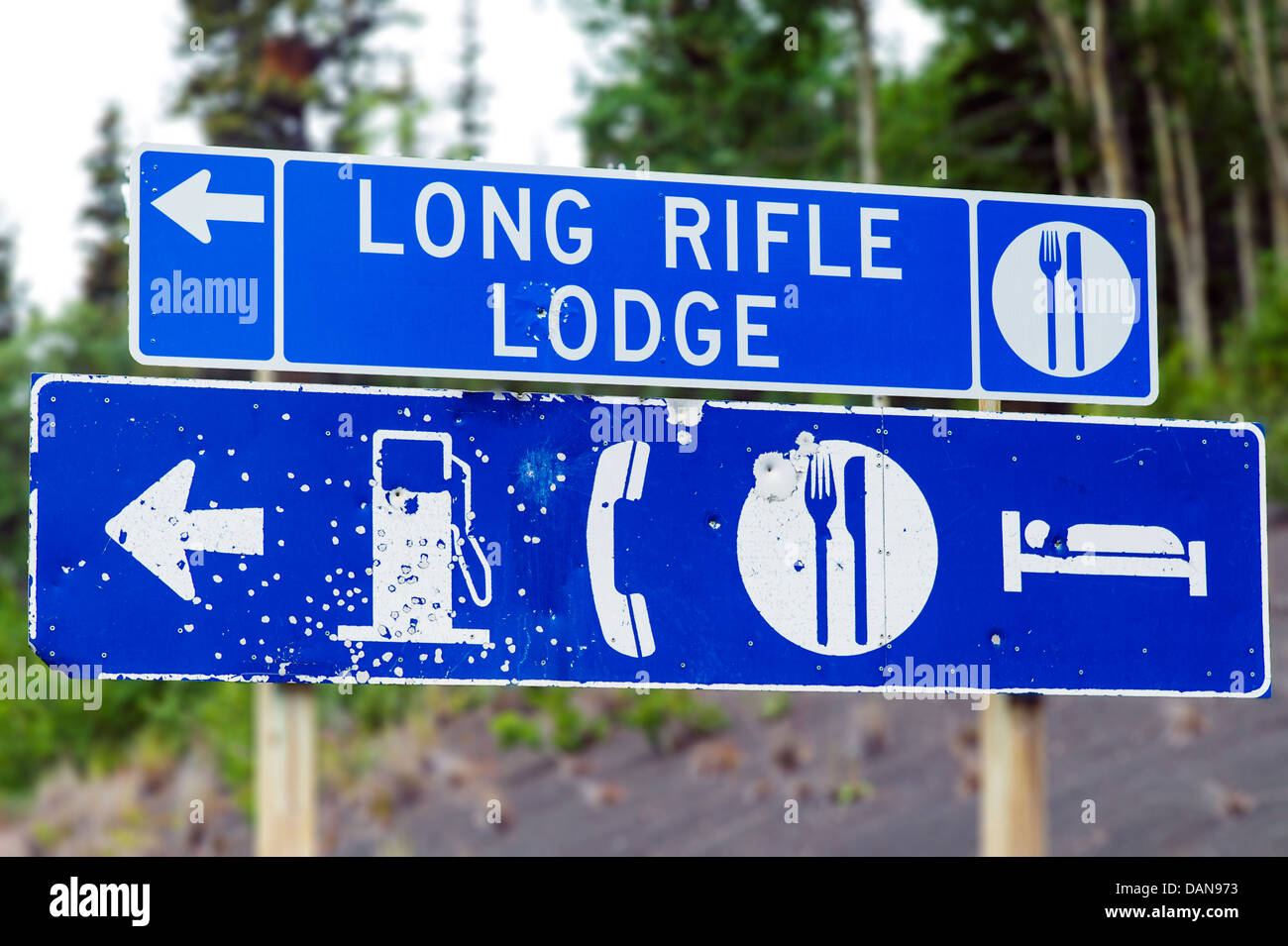 Long Rifle Lodge road sign with bullet holes, Glen Highway; Highway 1, Alaska, USA Stock Photo