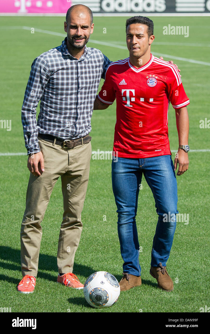 Munich, Germany. 16th July, 2013. Munich's head coach Pep Guardiola (L)  introduces new player Thiago Alcantara (