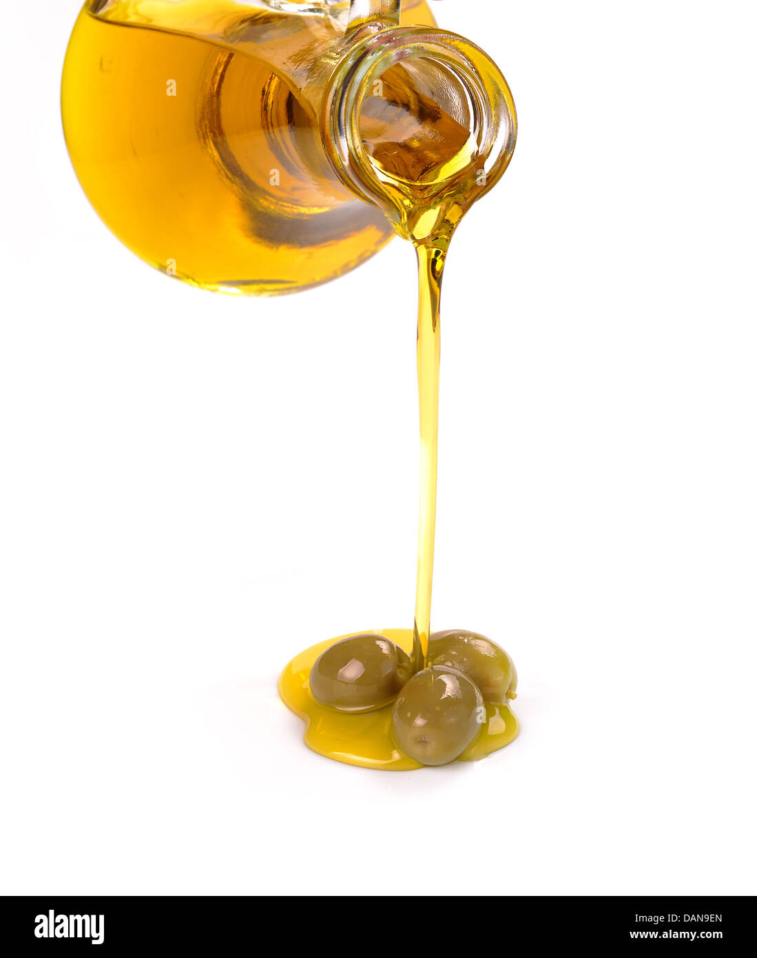 olive oil pouring from a bottle Stock Photo