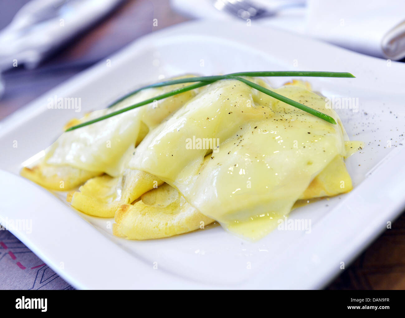 crepes with cheese and white mushroom and baked with grated cheese Stock Photo