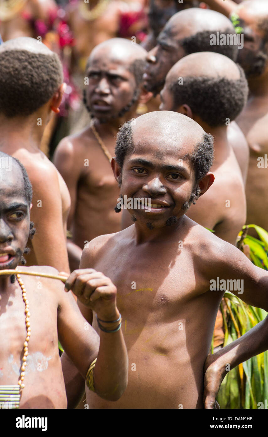 Young boys with shaved heads and made to look like men in a tribal group at the Goroka Festival, Papua New Guinea Stock Photo