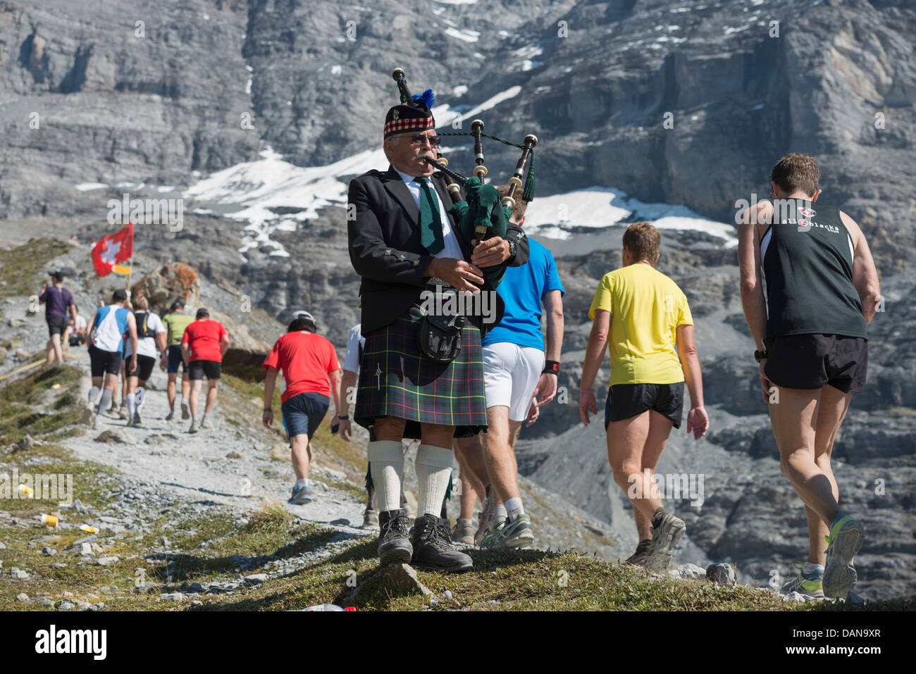 Europe, Swiss Alps, Switzerland, Bernese Oberland, Unesco, bagpipe player supporting the Jungfrau marathon Stock Photo
