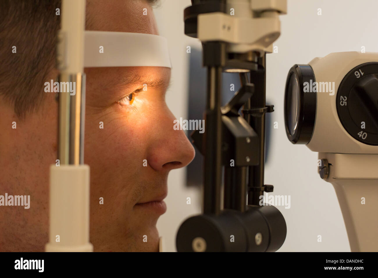 Patient or customer at slit lamp at optometrist or optician Stock Photo