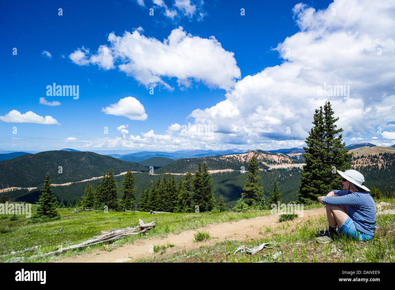 Lone woman pausing to enjoy the view, Monarch Crest Trail, Central Colorado, USA Stock Photo