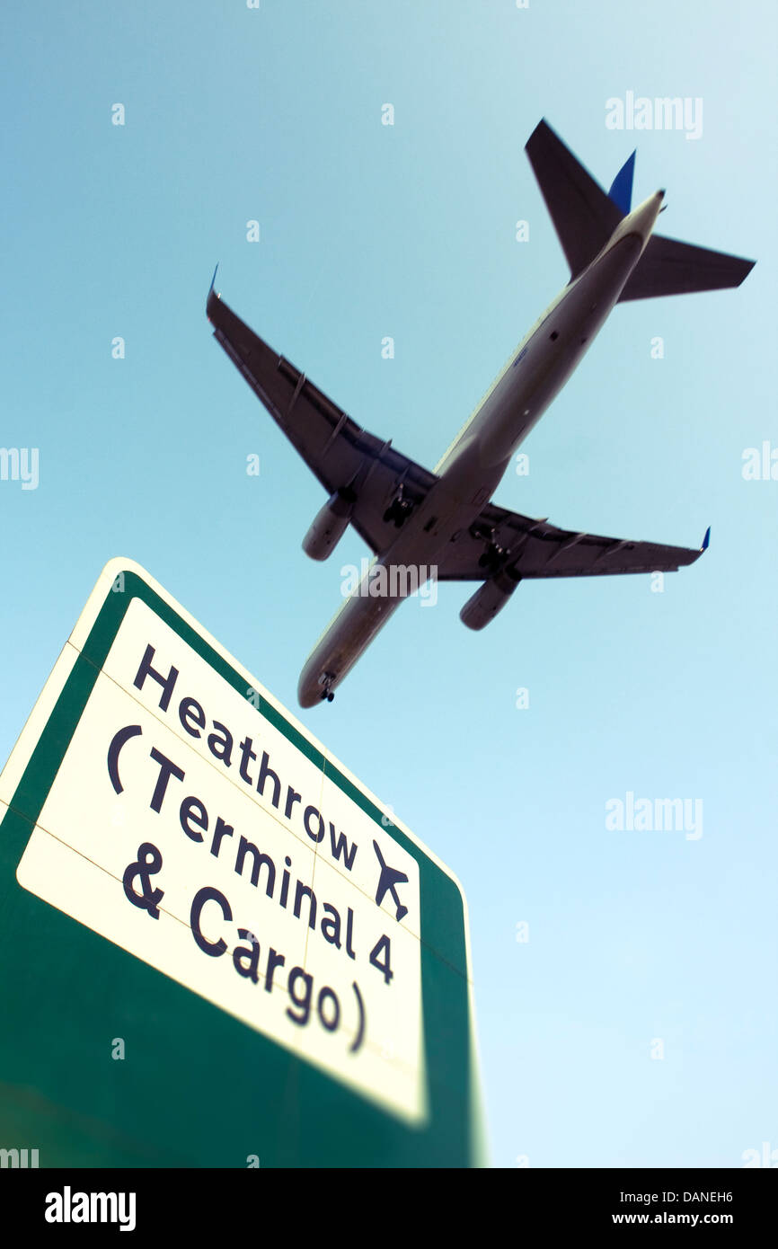Commercial airliner and Heathrow sign Stock Photo
