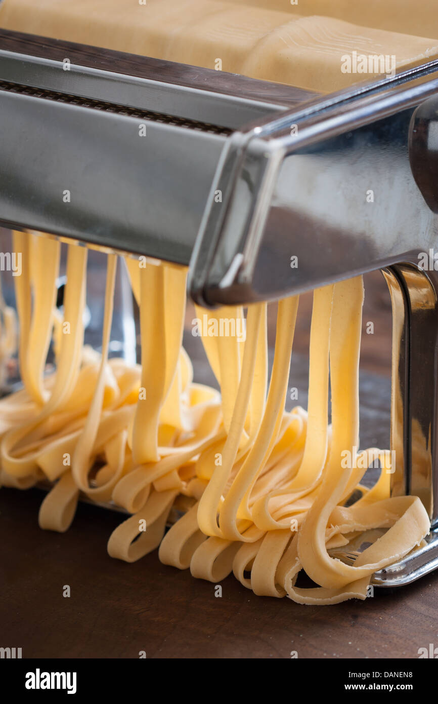 Making tagliatelle with a traditional pasta machine Stock Photo Alamy
