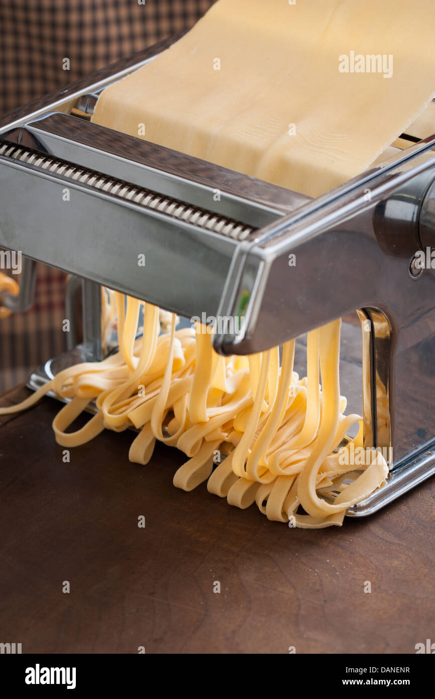 https://c8.alamy.com/comp/DANENR/making-tagliatelle-with-a-traditional-pasta-machine-DANENR.jpg