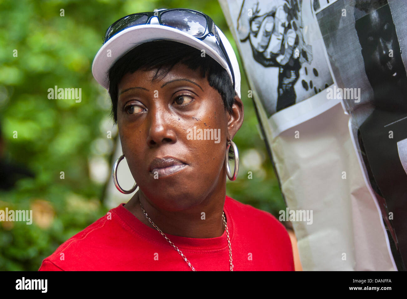 London, UK. 16th July, 2013. A woman with her placard as protesters demonstrated outside the US embassy in London against the acquittal of George Zimmerman who shot 17 year-old Trayvon Martin in Florida. Credit:  Paul Davey/Alamy Live News Stock Photo