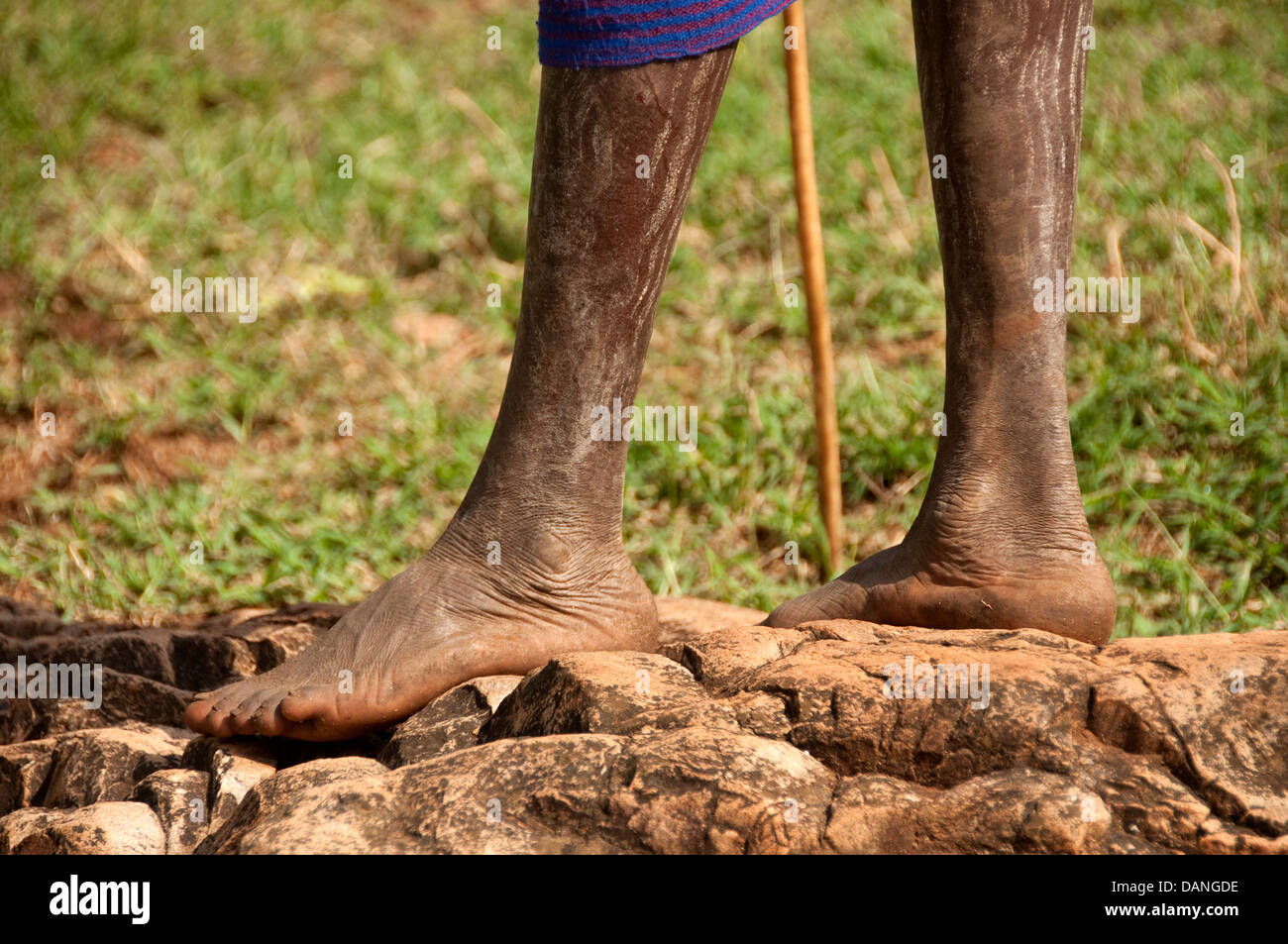 Feet of a Suri (Surma) shepherd with a pole, Ethiopia Stock Photo