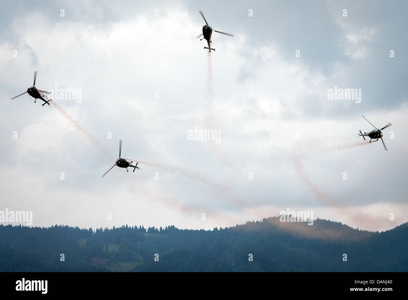 Dynamic pershow of four Austrian helicopters at Airpower 2013 airshow in Zeltweg, Austria, June 28, 2013 Stock Photo