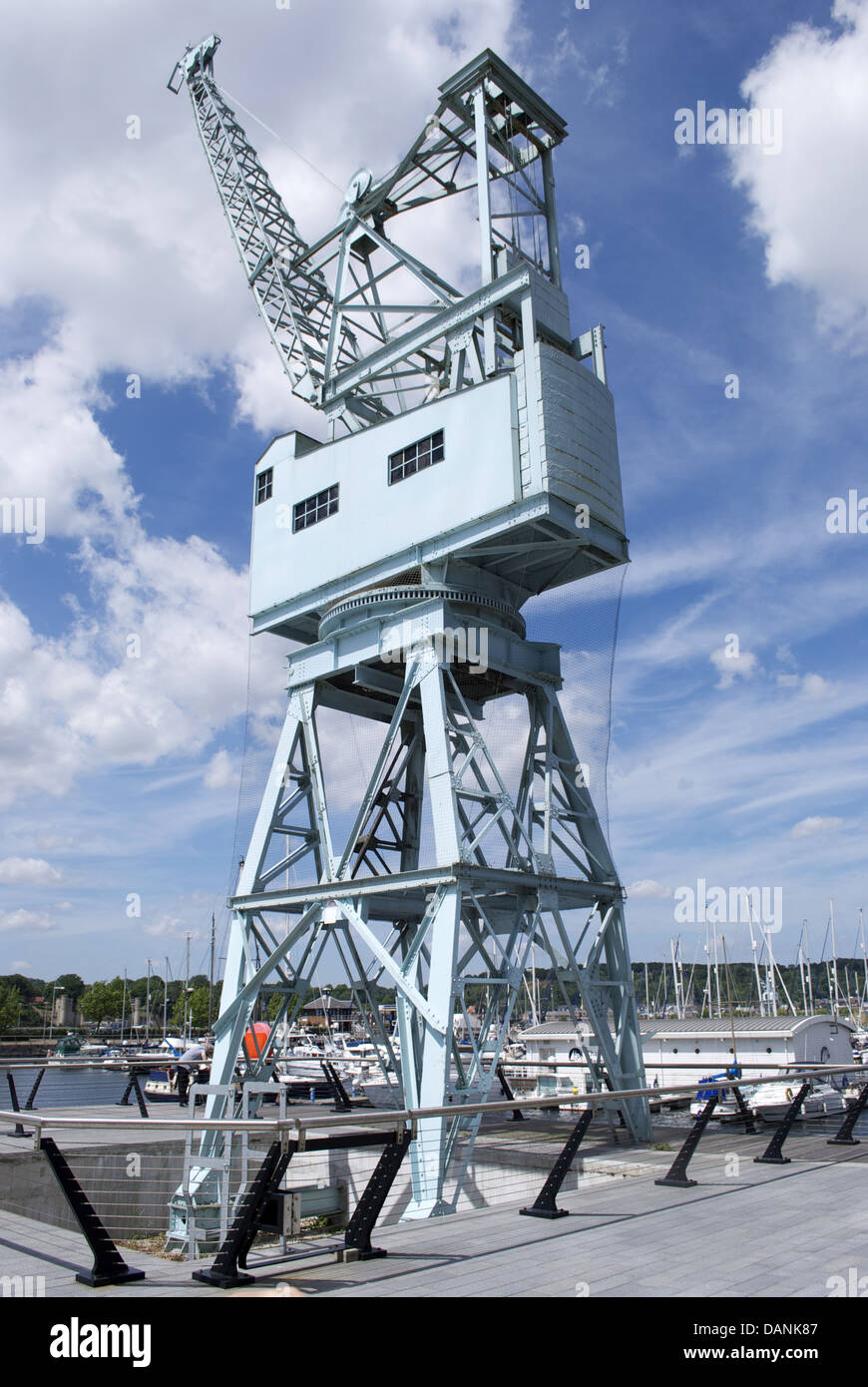 Dockside crane blue and cloudy sky backdrop angled at forty five degrees Stock Photo