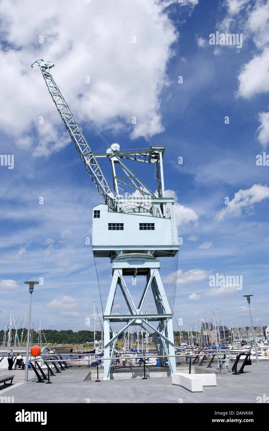 Dockside crane blue and cloudy sky backdrop Stock Photo - Alamy