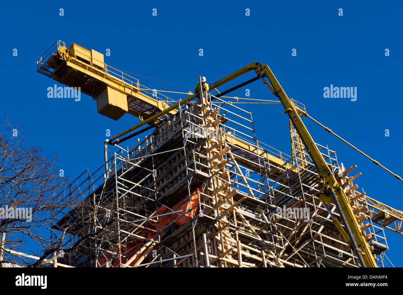A truck pumps concrete into formwork high on the Halifax Central Library, Nova Scotia, Canada. Stock Photo