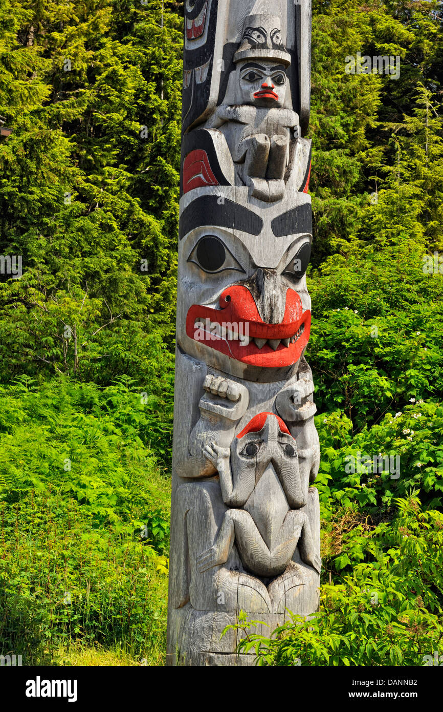 Frontal pole with Watchman above a bear frog below Haida Gwaii Queen Charlotte Islands- Old Masset British Columbia Canada Stock Photo