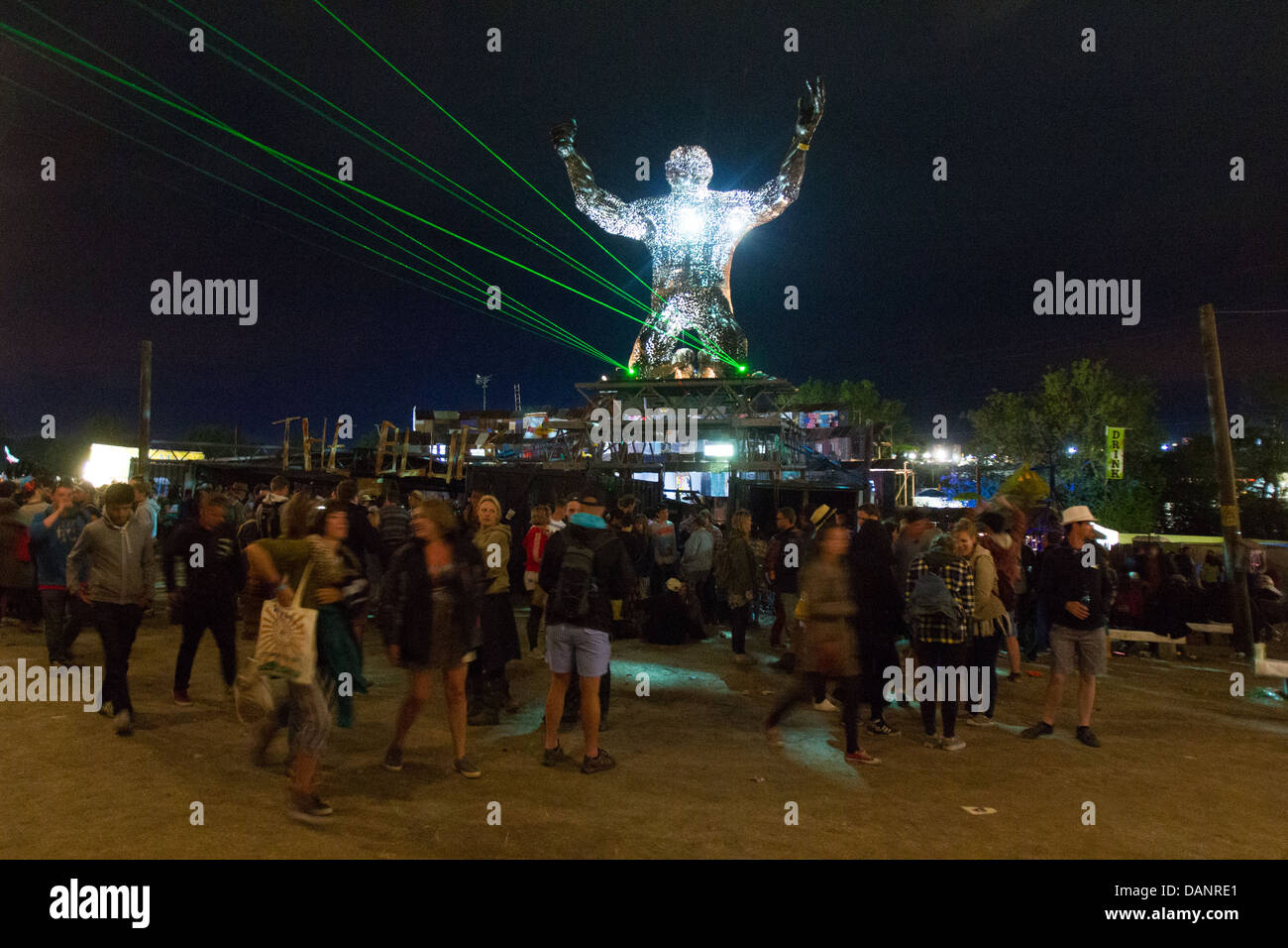 Statue of a giant man on his knees in the Silver Hayes arena, Glastonbury Festival 2013 Stock Photo