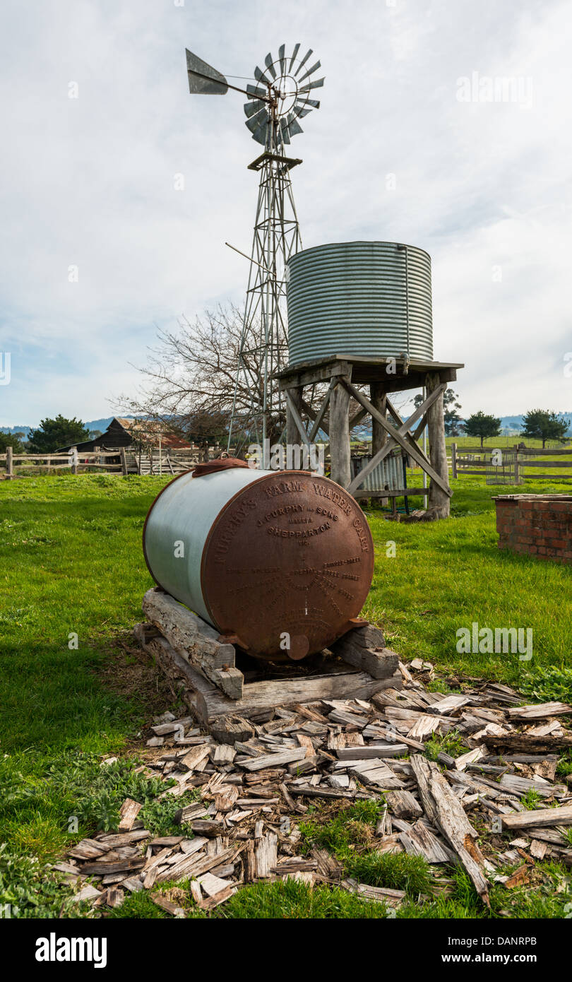 Australian windmill and water tank on an old sheep farm. Stock Photo