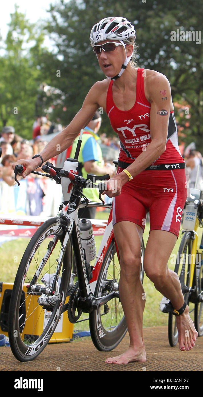 British triathlete Chrissie Wellington gets on her bike after the swimming etappe during the 10th Ironman Challenge in Roth, Germany, 10 July 2011. For the ironman, the participants have to swim 3,8 km, cycle 180 km and run 42,195 km. Photo: Daniel Karmann Stock Photo