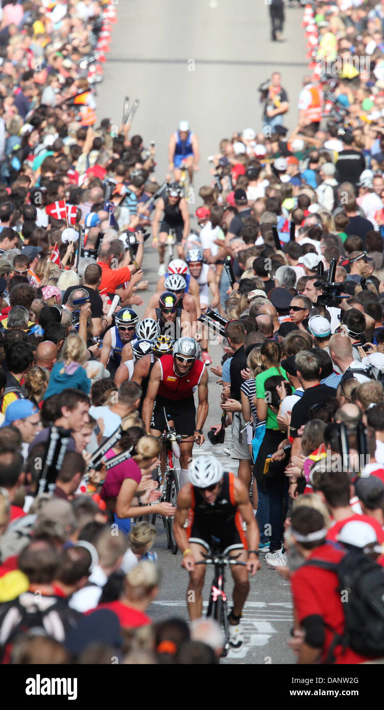 Triathletes ride uphill during the cycling etappe of the 10th Ironman Challenge in Hipoltstein, Germany, 10 July 2011. For the ironman, the participants have to swim 3,8 km, cycle 180 km and run 42,195 km. Photo: Daniel Karmann Stock Photo
