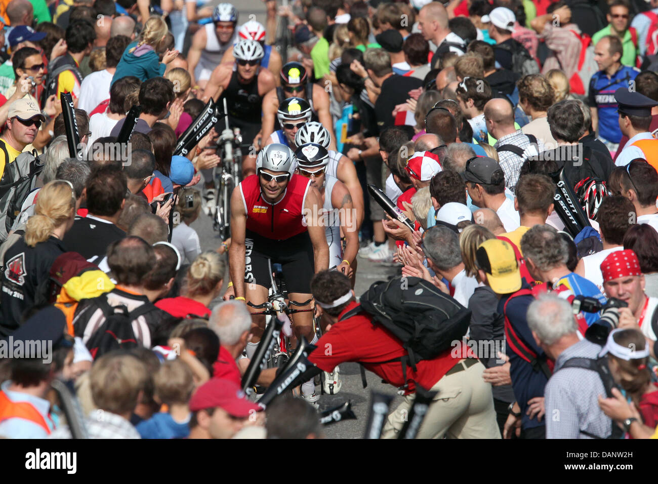 Triathletes ride uphill during the cycling etappe of the 10th Ironman Challenge in Hipoltstein, Germany, 10 July 2011. For the ironman, the participants have to swim 3,8 km, cycle 180 km and run 42,195 km. Photo: Daniel Karmann Stock Photo