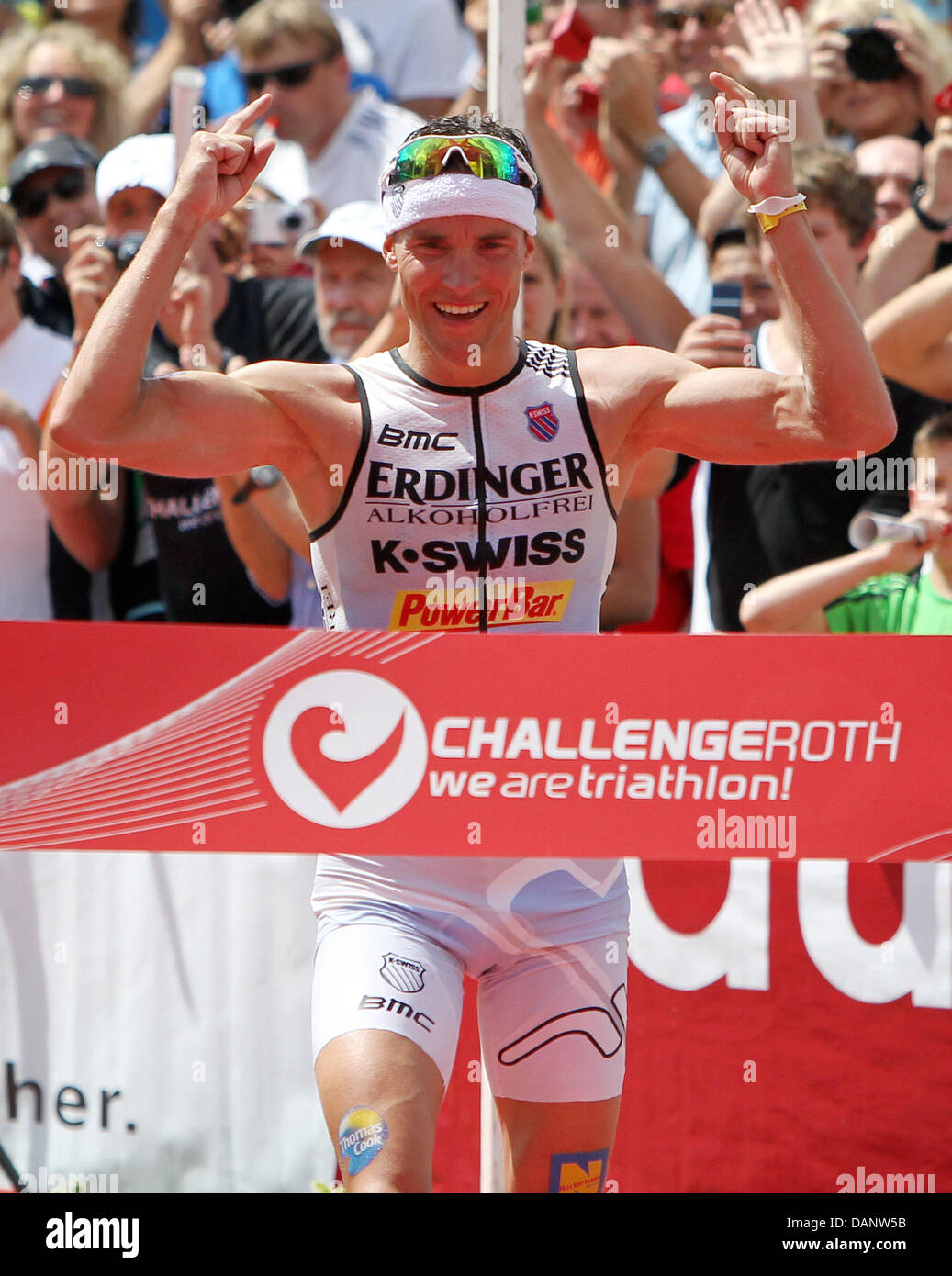 German triathlete Andreas Raelert cheers after the cycling etappe of the 10th Ironman Challenge in Hipoltstein, Germany, 10 July 2011. Andreas Raelert has won first place and made a new world record. For the ironman, the participants have to swim 3,8 km, cycle 180 km and run 42,195 km. Photo: Daniel Karmann Stock Photo