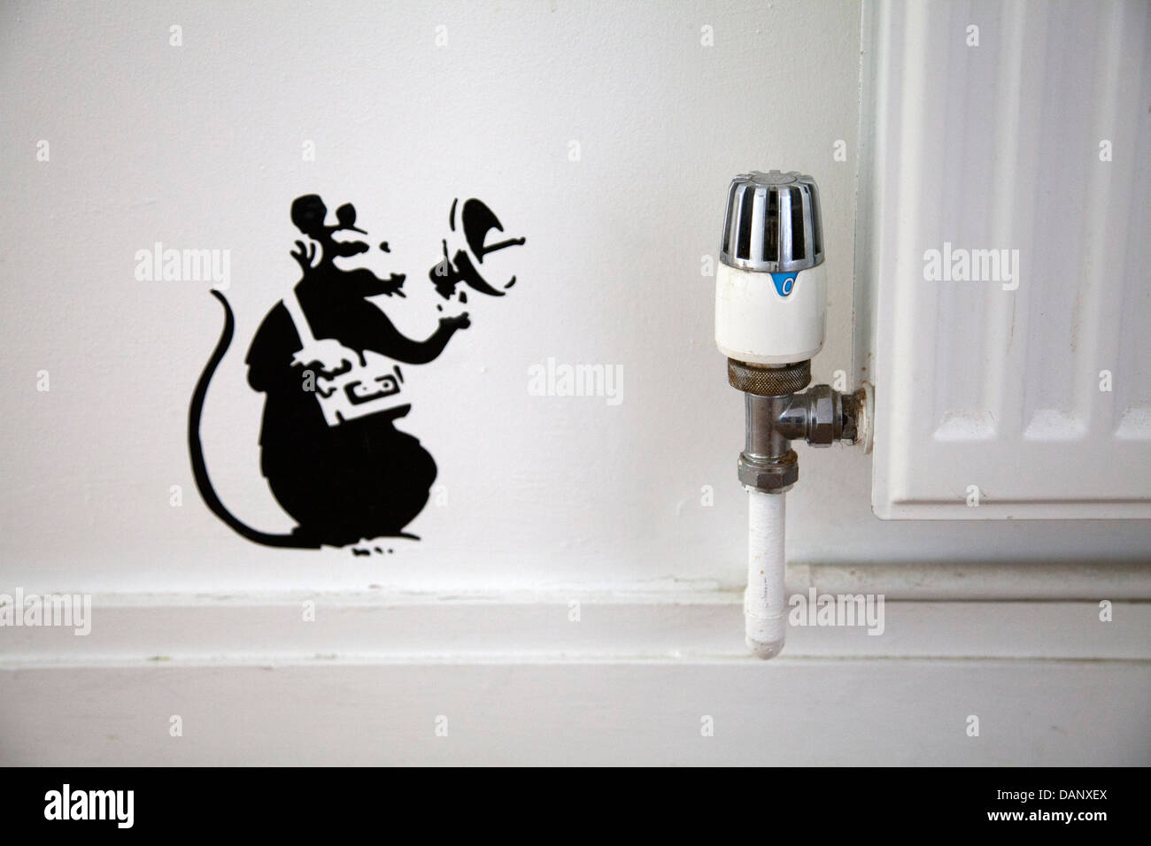 Mouse with Sound Detector Graffiti Stencil in Interior next to Radiator Stock Photo