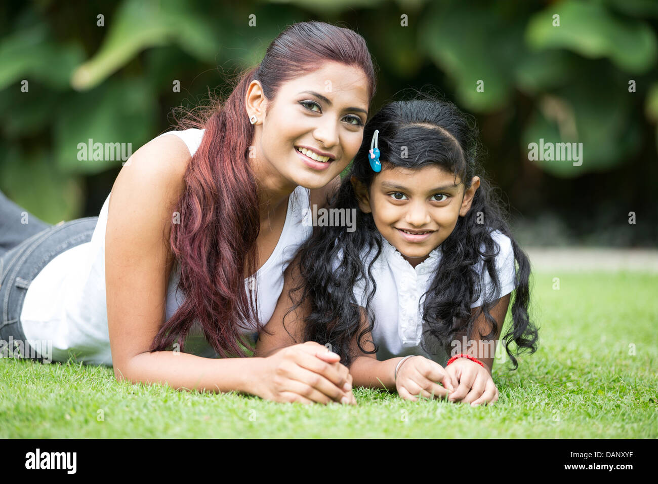 Happy Indian mother and daughter playing in the park. Lifestyle image. Stock Photo