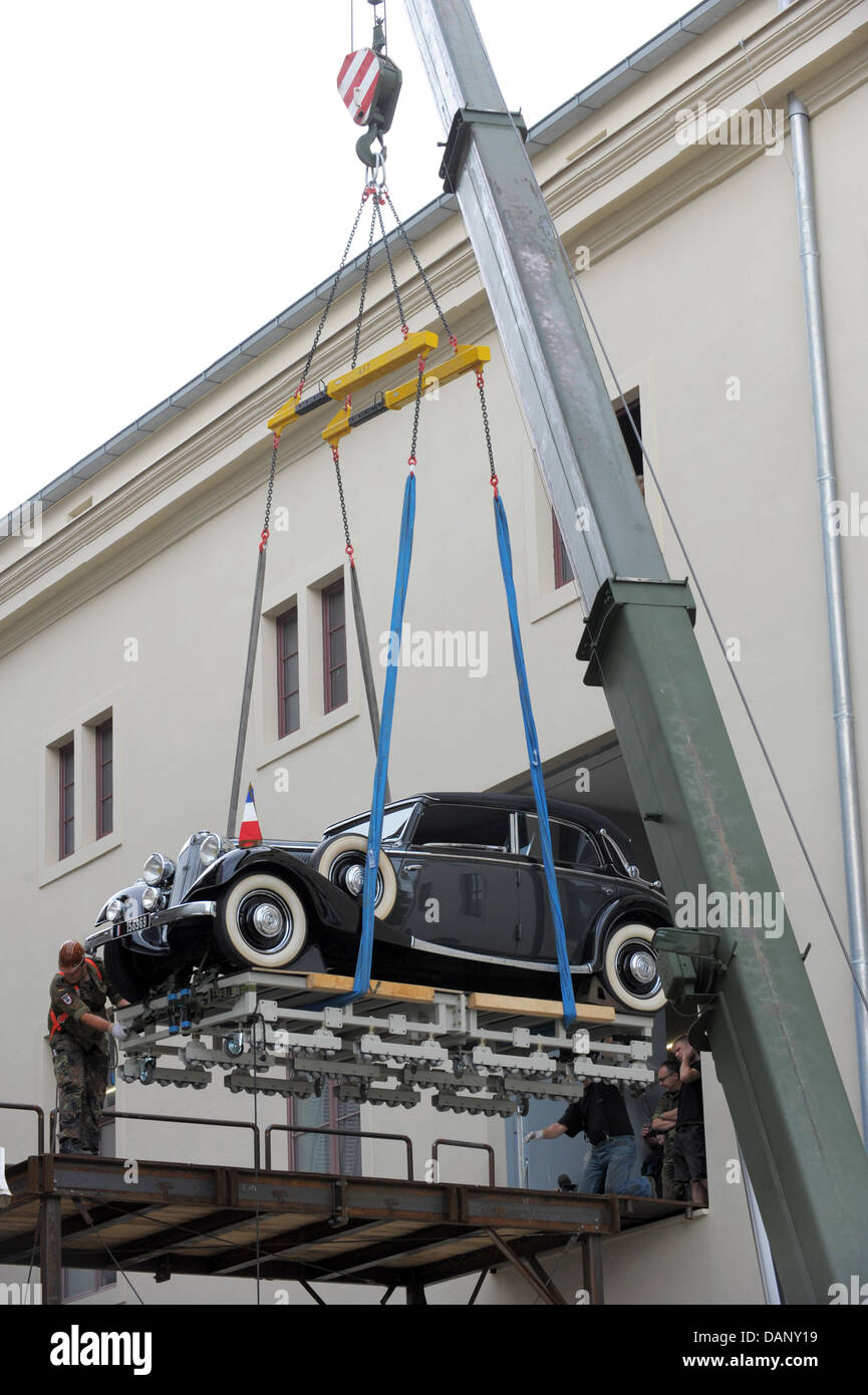 The vehicle with which French General and President Charles de Gaulle (1890-1970) attended parades is lifted with a crane at the Military History Museum of the German Bundeswehr (Armed Forces) in Dresden, Germany, 14 July 2011. The car Horch 830 BL Sedan-Cabriolet was brought from the Audi Museum in Ingolstadt to Dresden for a new permanent exhibition, which documents 700 years of  Stock Photo